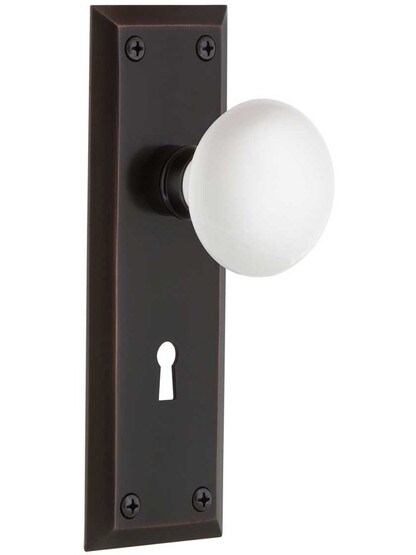 New York Style Door Set With White Porcelain Door Knobs in Timeless Bronze.